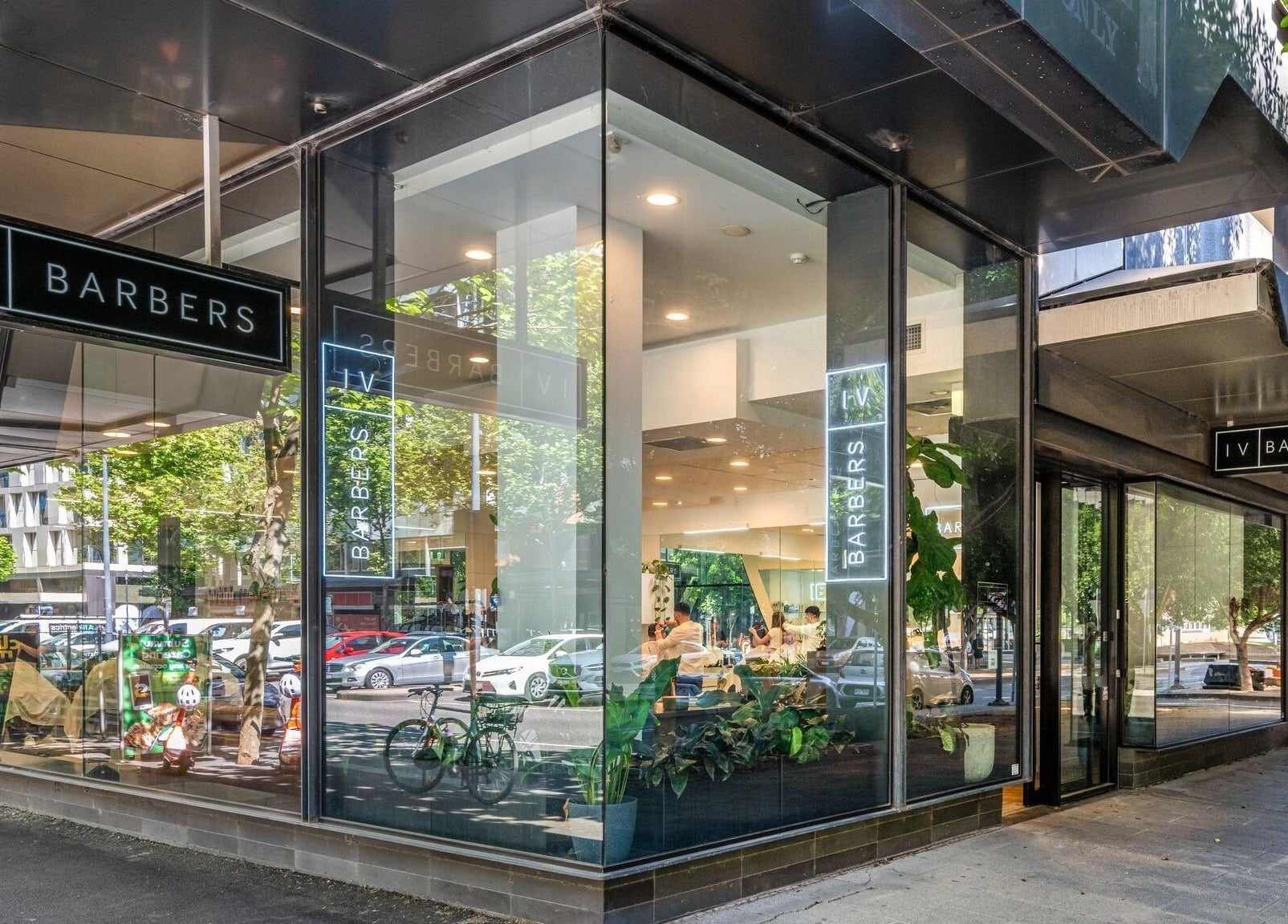 Front view of IV Barbers in Melbourne, Victoria, AU with glass windows and modern design.