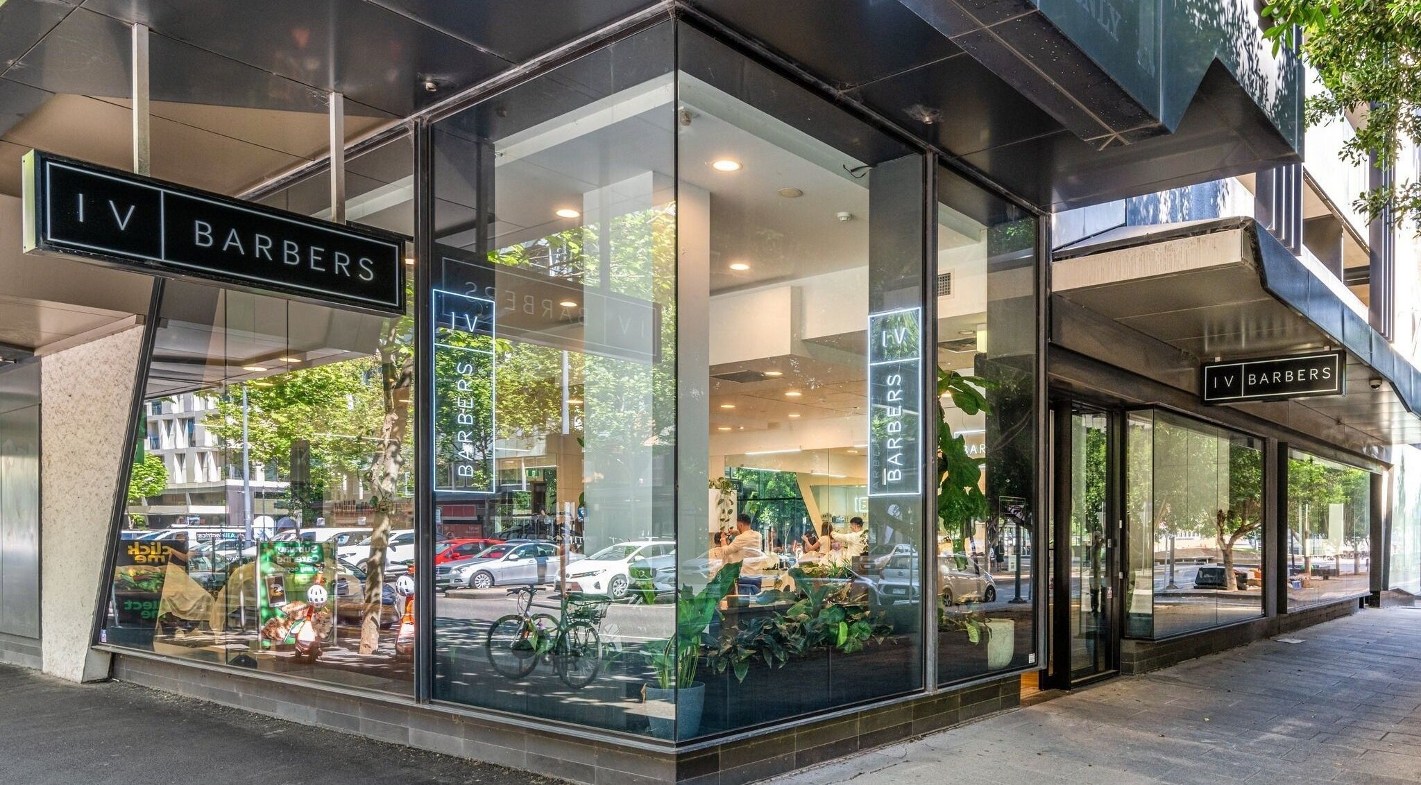 Front view of IV Barbers in Melbourne, Victoria, AU with glass windows and modern design.