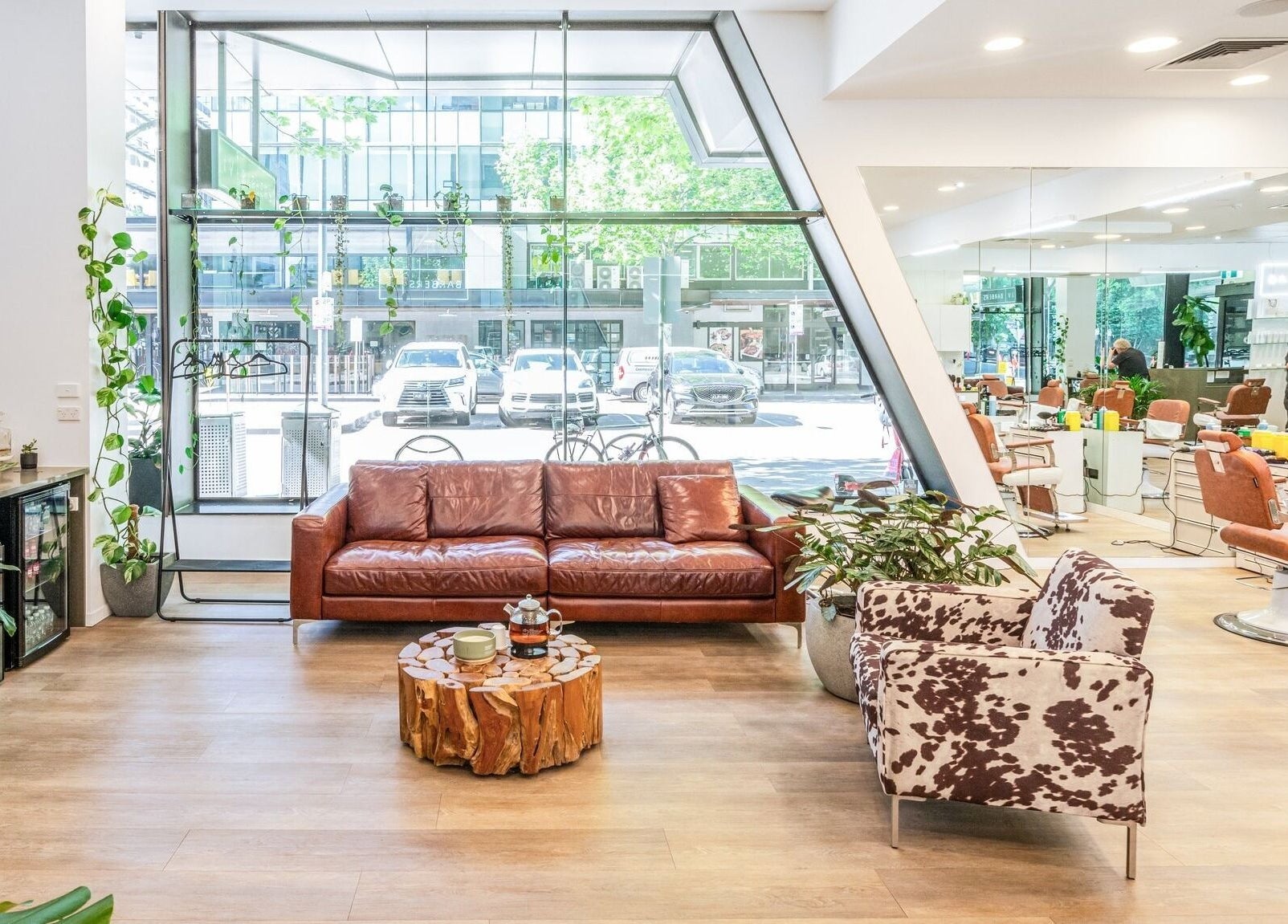 Stylish interior of IV Barbers in Melbourne, Victoria, AU with leather sofa and chic decor.