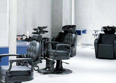 Modern barber chairs at 9CUTS Barber Shop, Riyadh I الرياض, SA, offering a sleek styling experience.