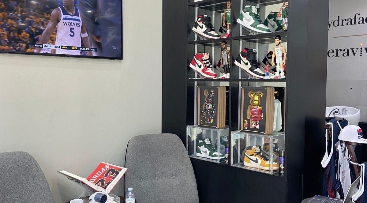 Stylish sneaker display at The Gents Salon, Dubai, Dubai, AE, with a modern seating area.