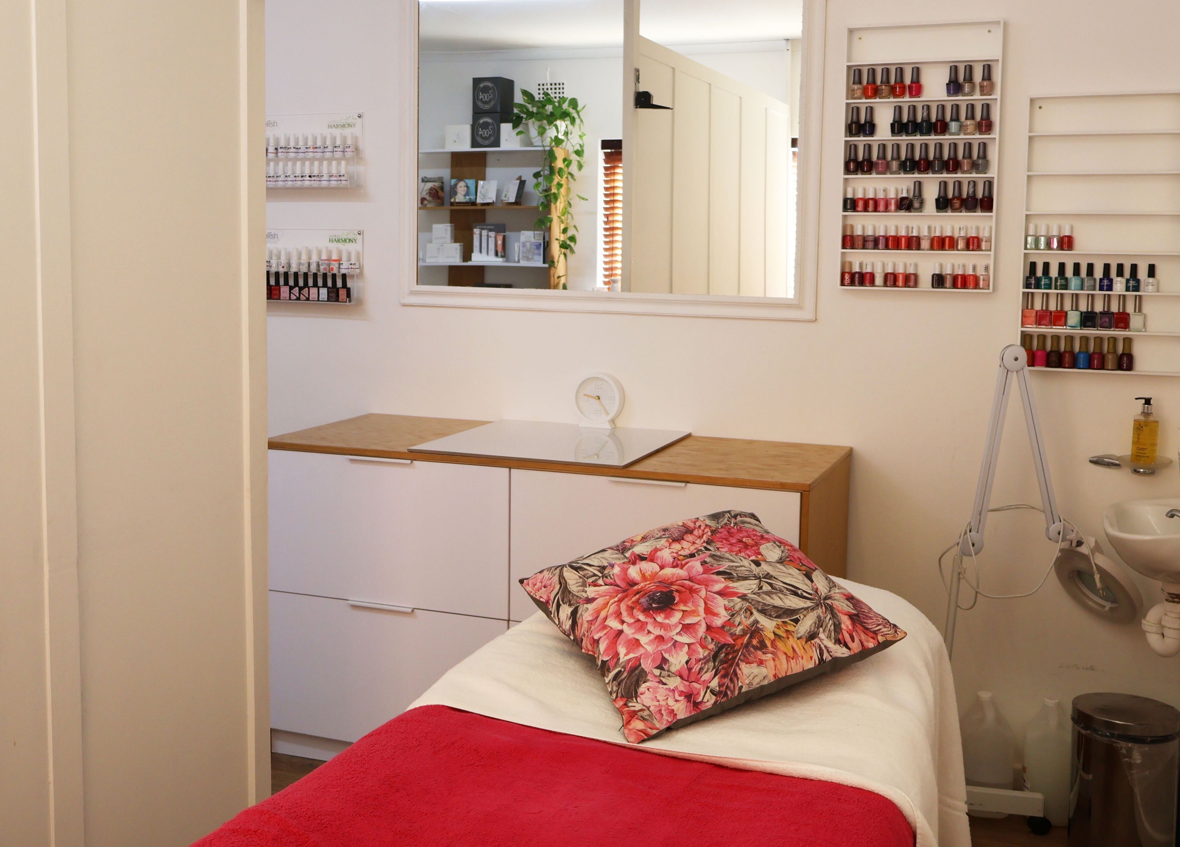 Cozy treatment room at Lindsay Jordaan Beauty Boutique, Cape Town, Western Cape, ZA with vibrant nail polish display.