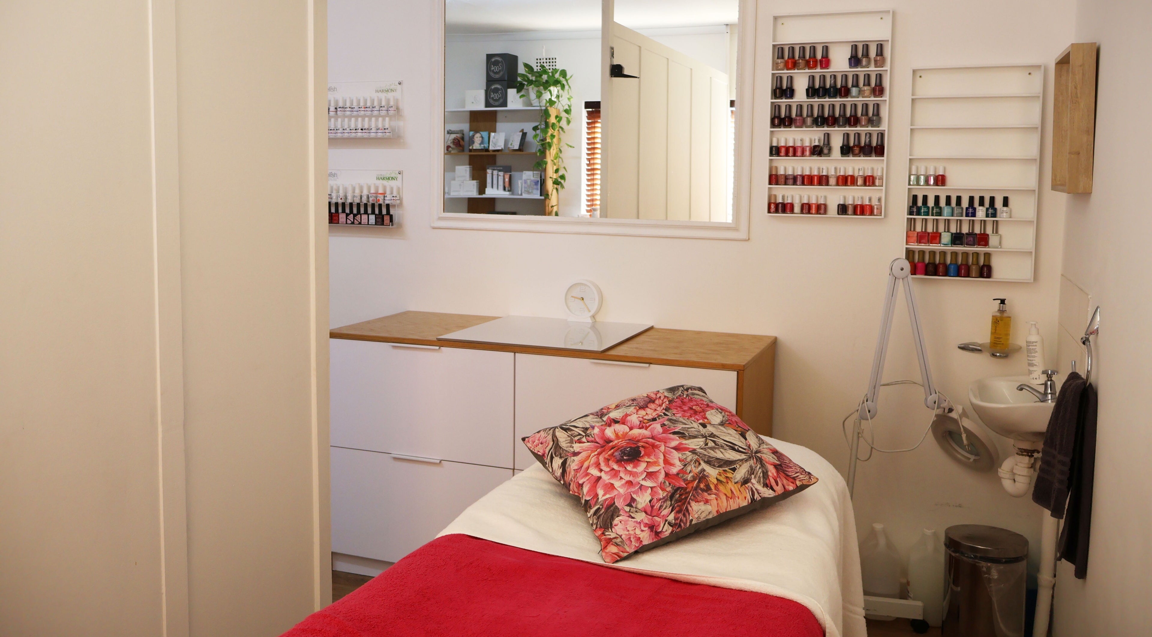 Cozy treatment room at Lindsay Jordaan Beauty Boutique, Cape Town, Western Cape, ZA with vibrant nail polish display.