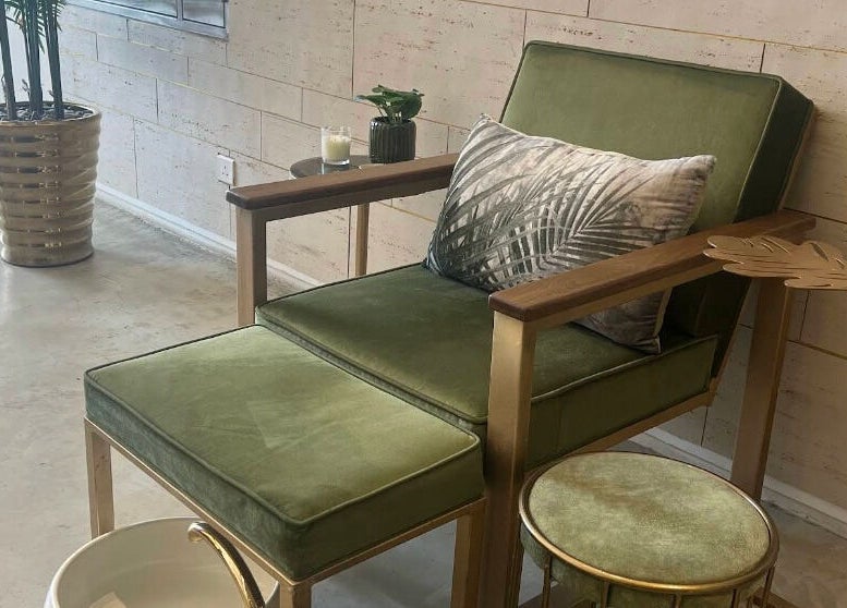 Relaxing green chair with footrest at Oaks, Riyadh, Riyadh Province, SA in a stylish, modern room.
