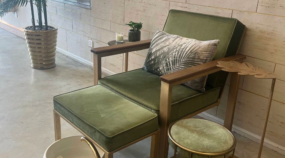 Relaxing green chair with footrest at Oaks, Riyadh, Riyadh Province, SA in a stylish, modern room.
