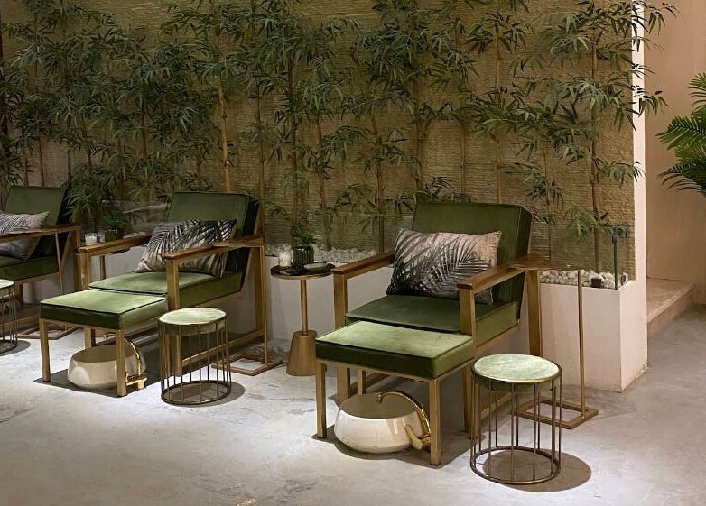 Relaxing seating at Oaks, Riyadh, Riyadh Province, SA, featuring plush green chairs and elegant decor.