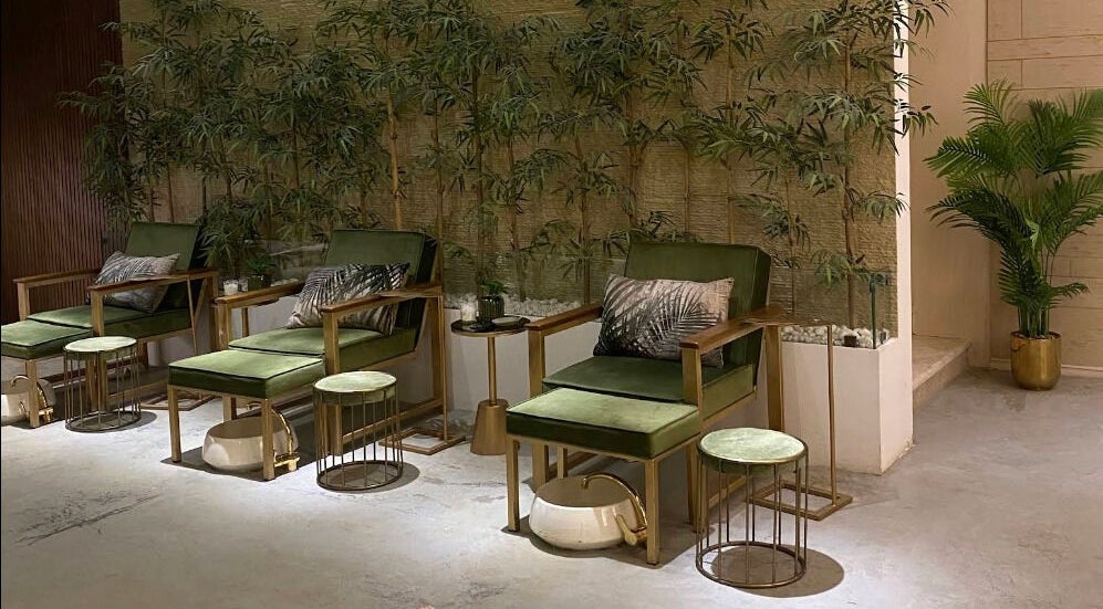Relaxing seating at Oaks, Riyadh, Riyadh Province, SA, featuring plush green chairs and elegant decor.