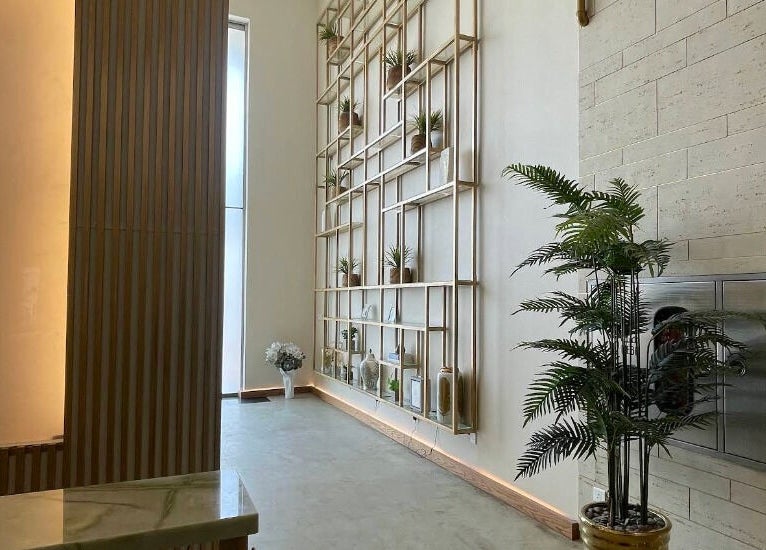 Sophisticated interior design at Oaks, Riyadh, Riyadh Province, SA with plants and wall shelving.