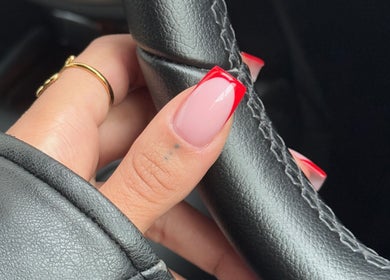 Stylish red-tipped nails at By Tiegan Natasha in Telford, England, GB; elegant nail art.