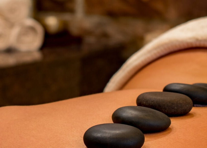 Hot stone massage at GLOW MASSAGE & AESTHETICS in Hamilton, Waikato, NZ offers relaxation and tranquility.