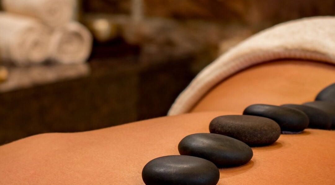 Hot stone massage at GLOW MASSAGE & AESTHETICS in Hamilton, Waikato, NZ offers relaxation and tranquility.