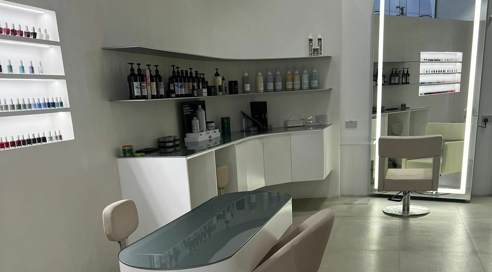 Modern nail station at Mauve Spa, Abu Dhabi, AE showcasing sleek design and extensive polish collection.