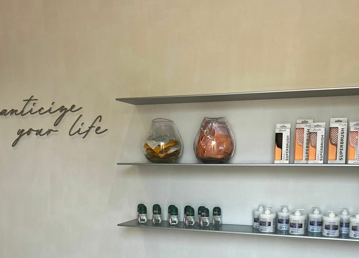 Elegant product shelves at Mauve Spa in Abu Dhabi, AE showcasing beauty items under a motivational quote.