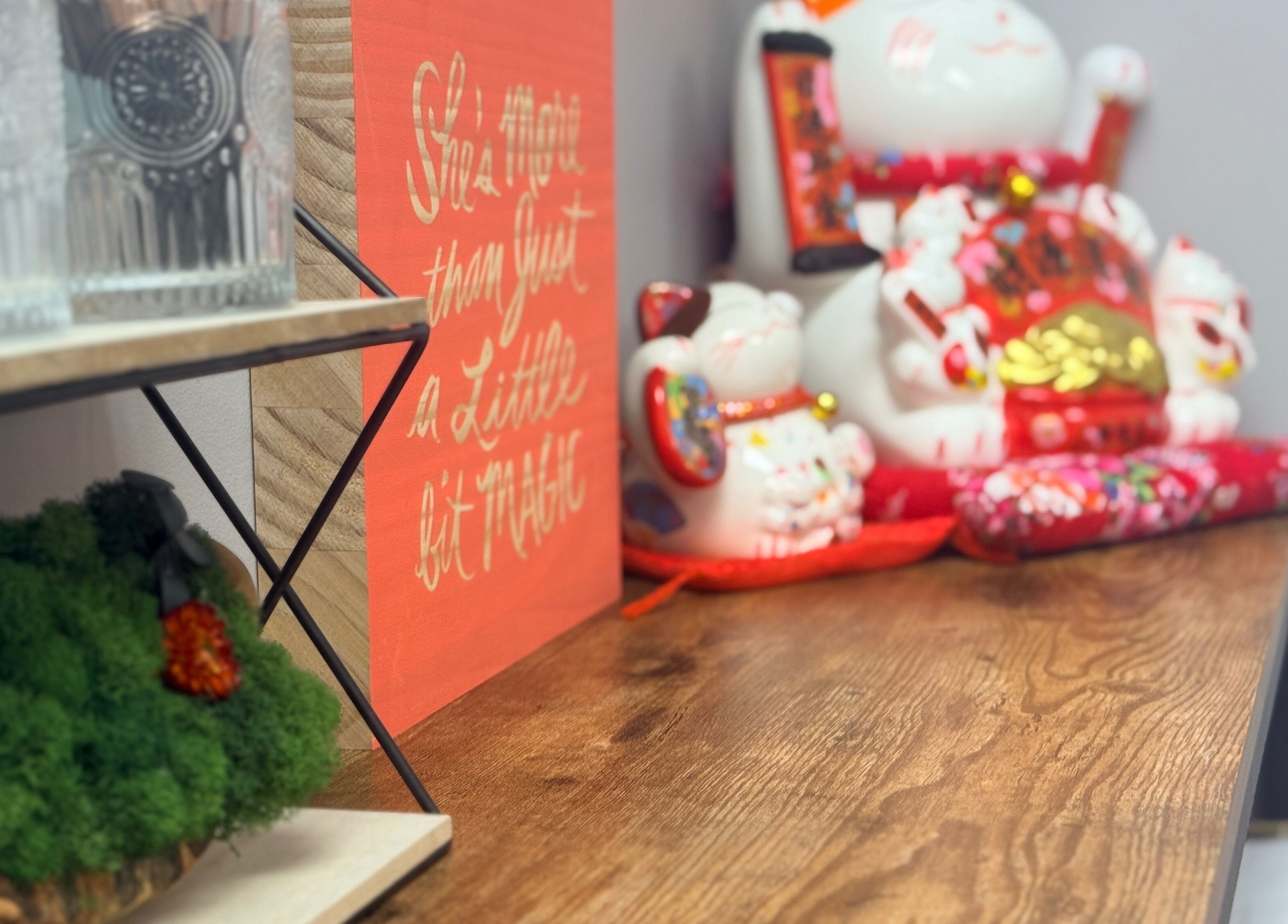 Decorative corner at Lash Brow, Edmonton, Alberta, CA with lucky cat and motivational art.