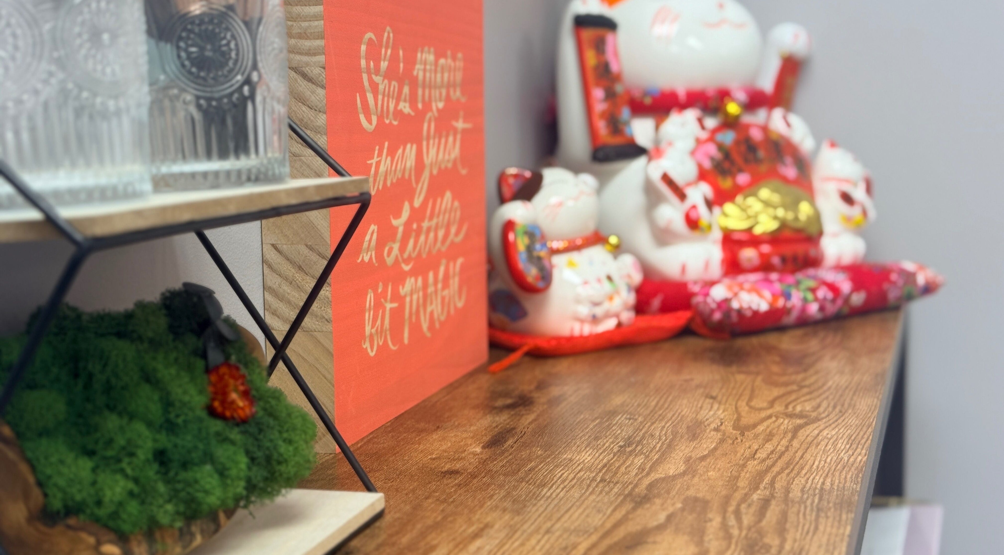 Decorative corner at Lash Brow, Edmonton, Alberta, CA with lucky cat and motivational art.