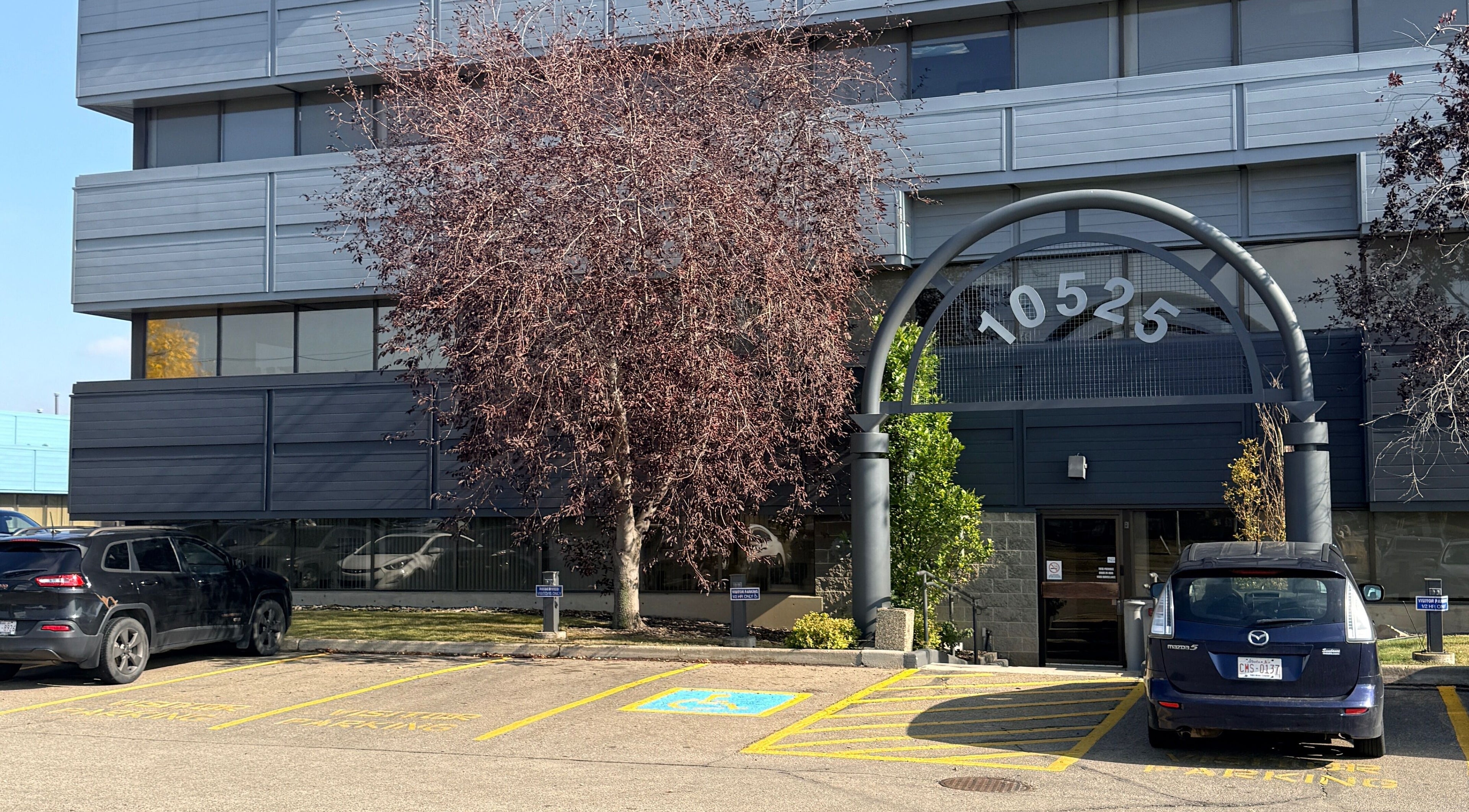 Entrance of Lash Brow in Edmonton, Alberta, CA, featuring modern building facade and parking.