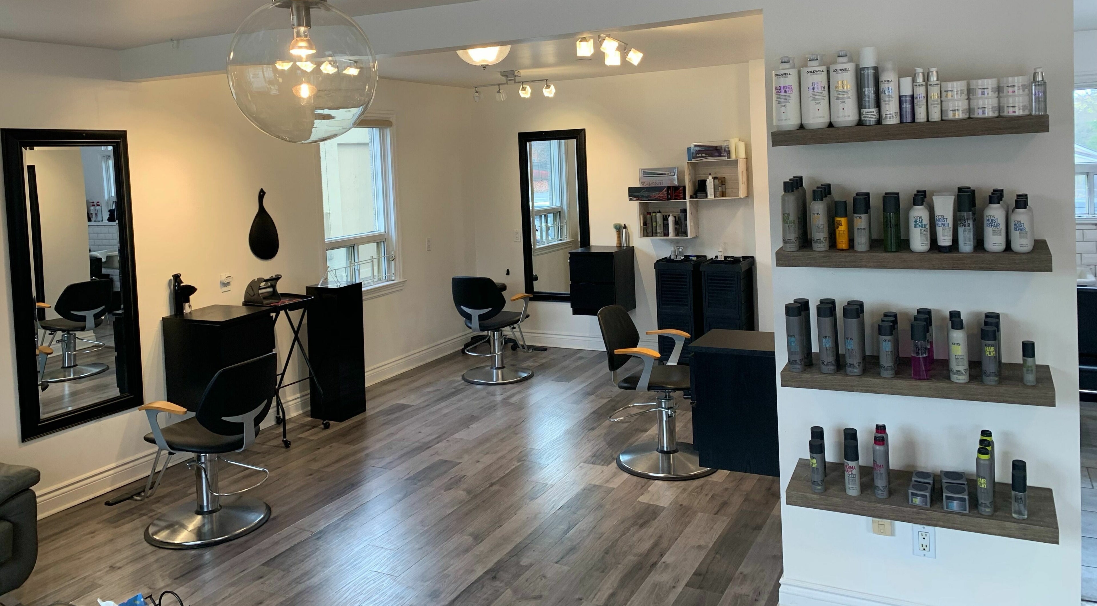 Modern and stylish interior of 5 One 7 Barbershop and Salon in Whitby, Ontario, CA with sleek chairs and products.