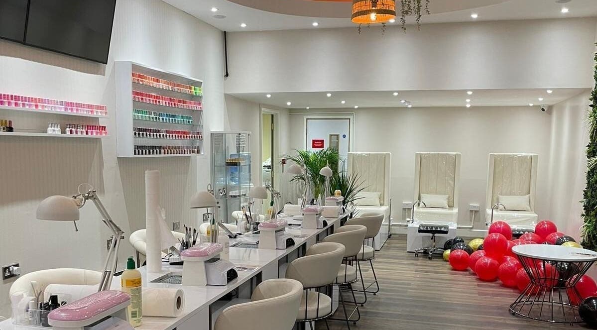 Elegant interior of Buddha Nail Studio, Brighton, England, GB, featuring nail stations and pedicure chairs.