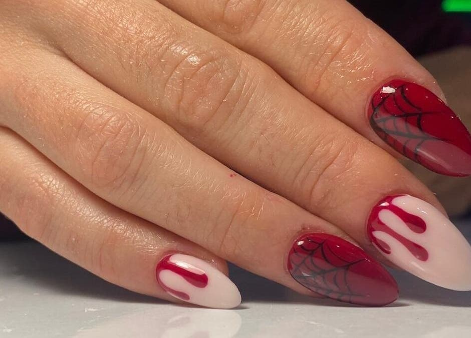 Intricate red nail art at Buddha Nail Studio, Brighton, England, GB, showcasing unique designs.