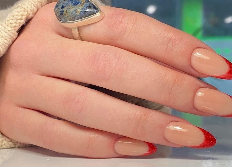 Elegant red French manicure at Buddha Nail Studio, Brighton, England, GB.