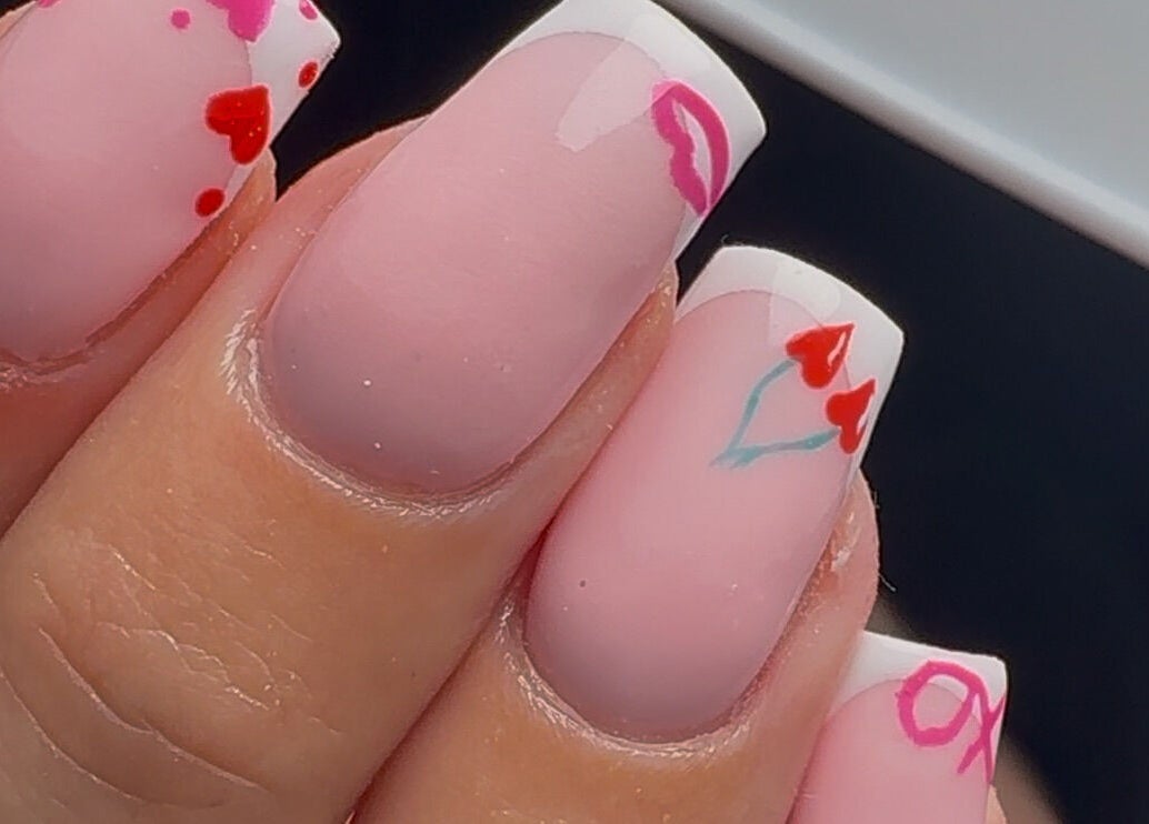 Elegant Valentine's nail art at Bymolh in Lichfield, England, GB featuring hearts and kisses.