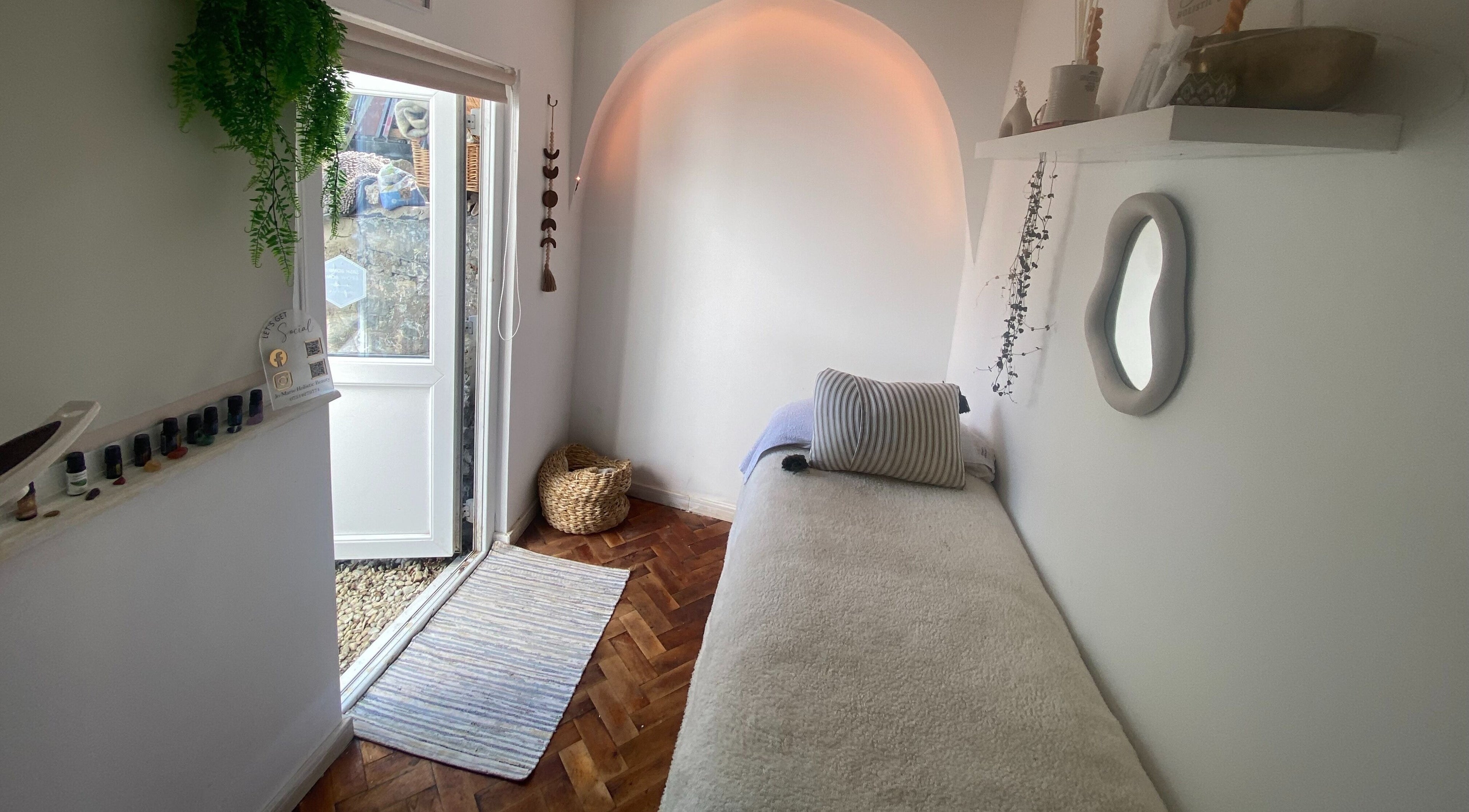 Calm treatment room at Jo Marie Holistic Beauty, Torquay, England, GB with soft lighting and cozy decor.