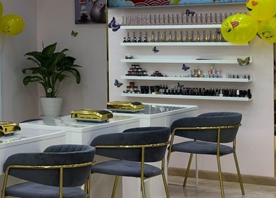 Elegant interior of Toplist Nail Beauty Salon in Dubai with modern chairs and shelves of products.