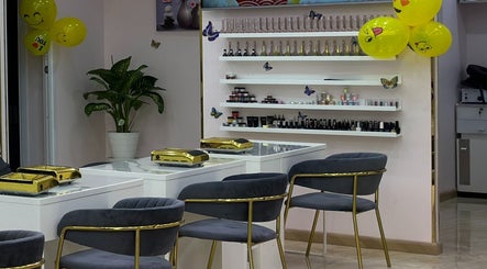 Elegant interior of Toplist Nail Beauty Salon in Dubai with modern chairs and shelves of products.