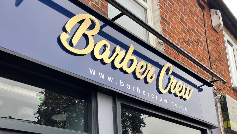 Exterior signage of Barber Crew Earley in Reading, England, GB showcasing its bold and stylish logo.