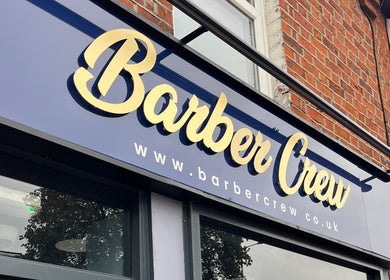 Exterior signage of Barber Crew Earley in Reading, England, GB showcasing its bold and stylish logo.