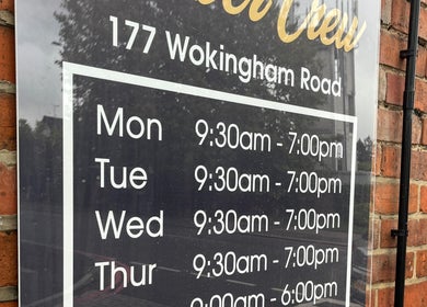 Barber Crew Earley operating hours sign at Wokingham Road, Reading, England, GB.