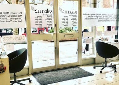 Inviting interior of Salon 112, Harlow, England, GB, showcasing chic seating and beauty product displays.