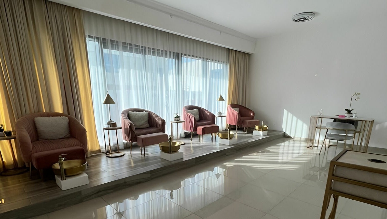 Interior of Hair and Nail Saloon Ajman featuring plush chairs and golden accents, located in عجمان, عجمان, AE.
