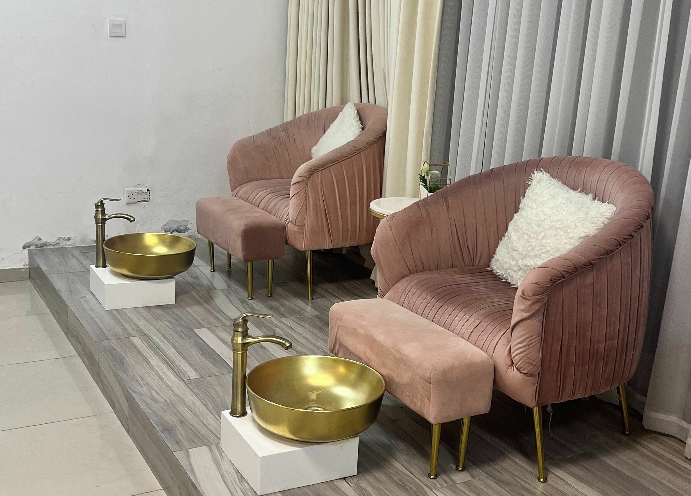 Elegant pedicure lounge at Hair and Nail Saloon Ajman, عجمان, عجمان, AE, with plush seating and golden bowls.