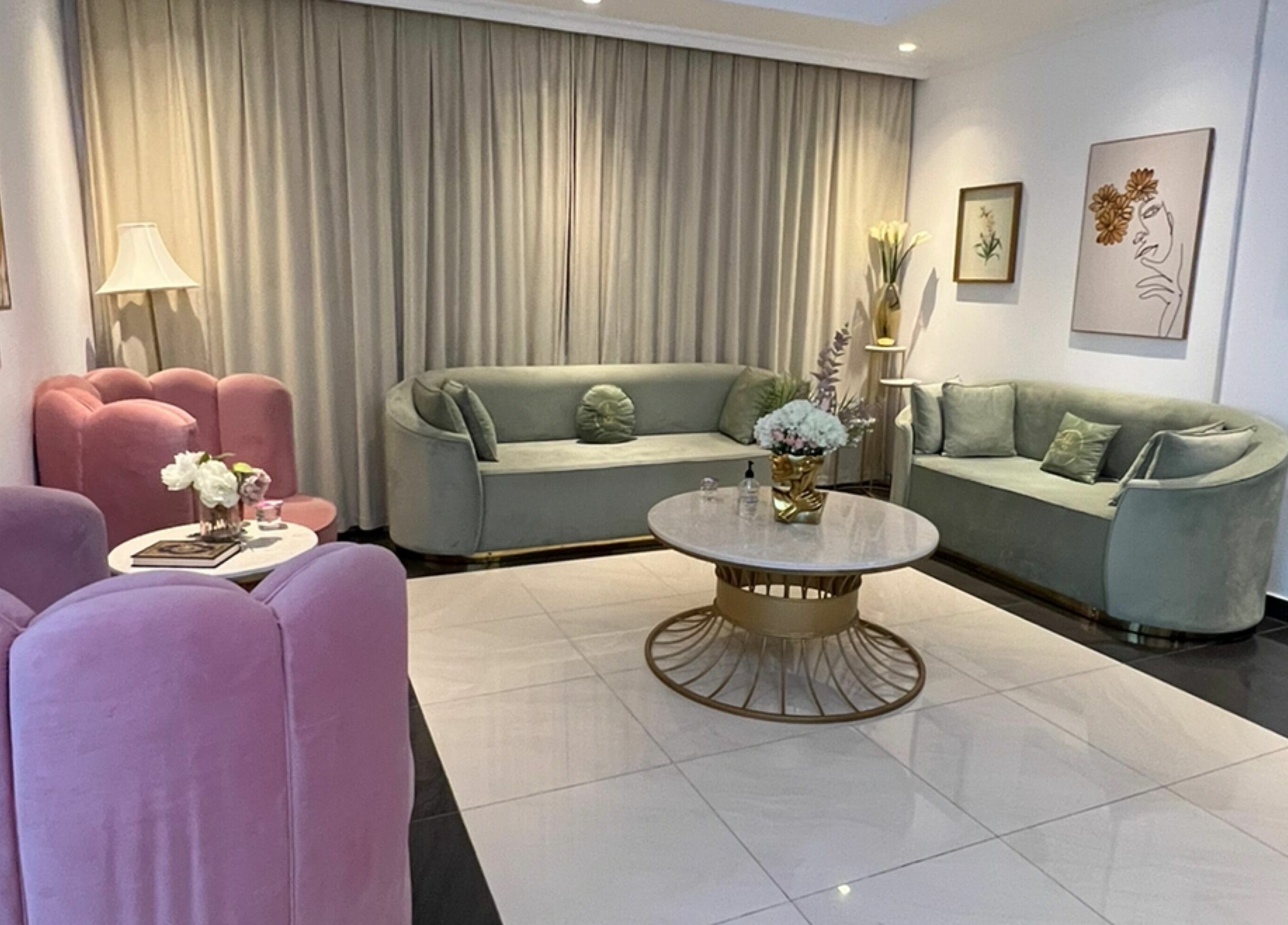 Chic sitting area in Hair and Nail Saloon Ajman, عجمان, عجمان, AE with pastel sofas and elegant decor.