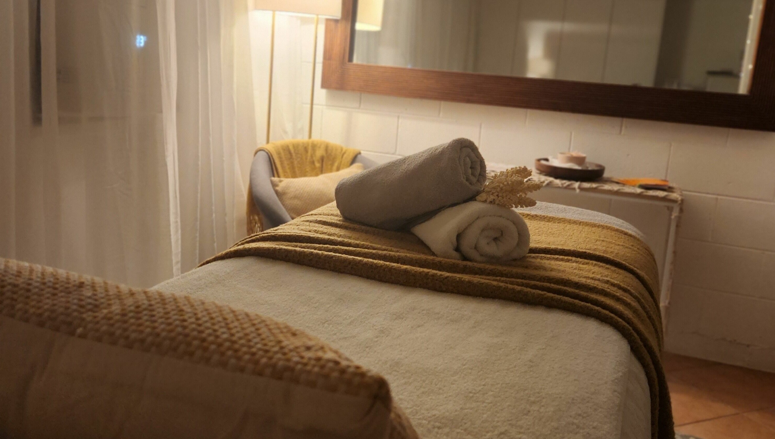 Cozy spa room at Authentic Zen Beauty in New Auckland, Queensland, AU, with soft lighting and fresh towels.