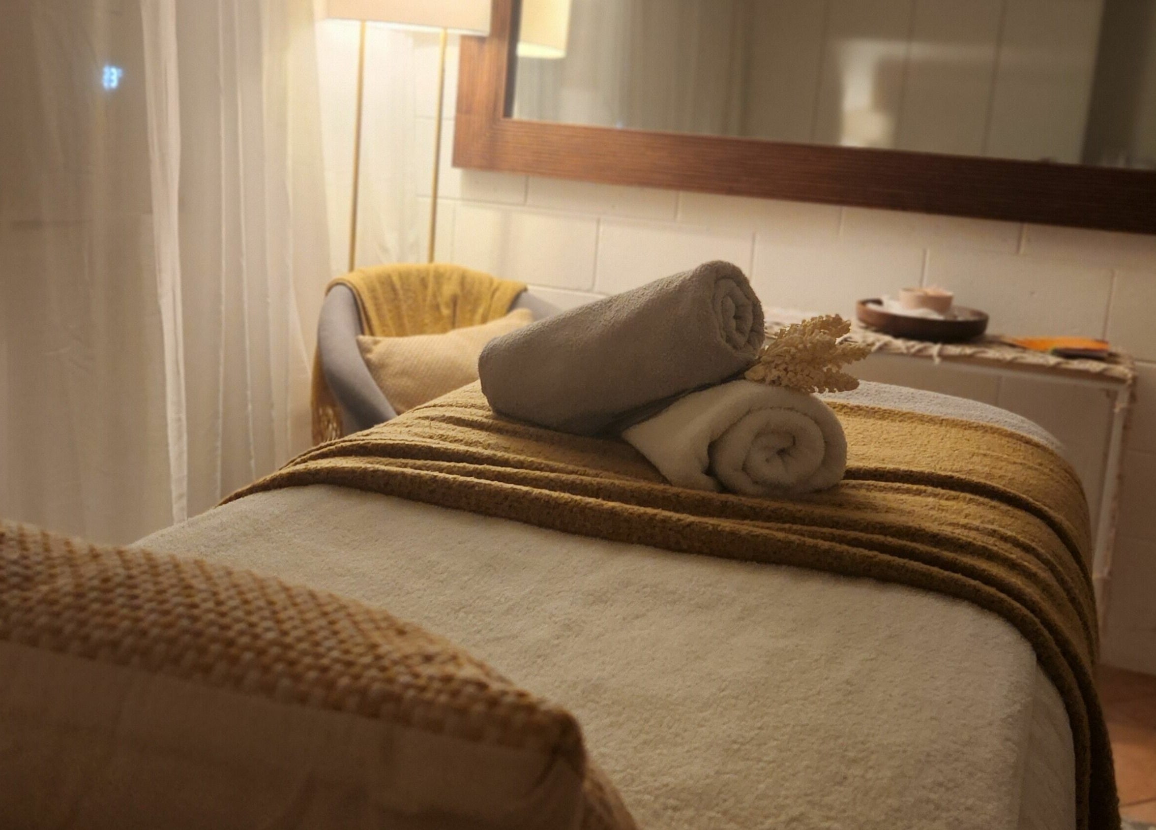 Cozy spa room at Authentic Zen Beauty in New Auckland, Queensland, AU, with soft lighting and fresh towels.