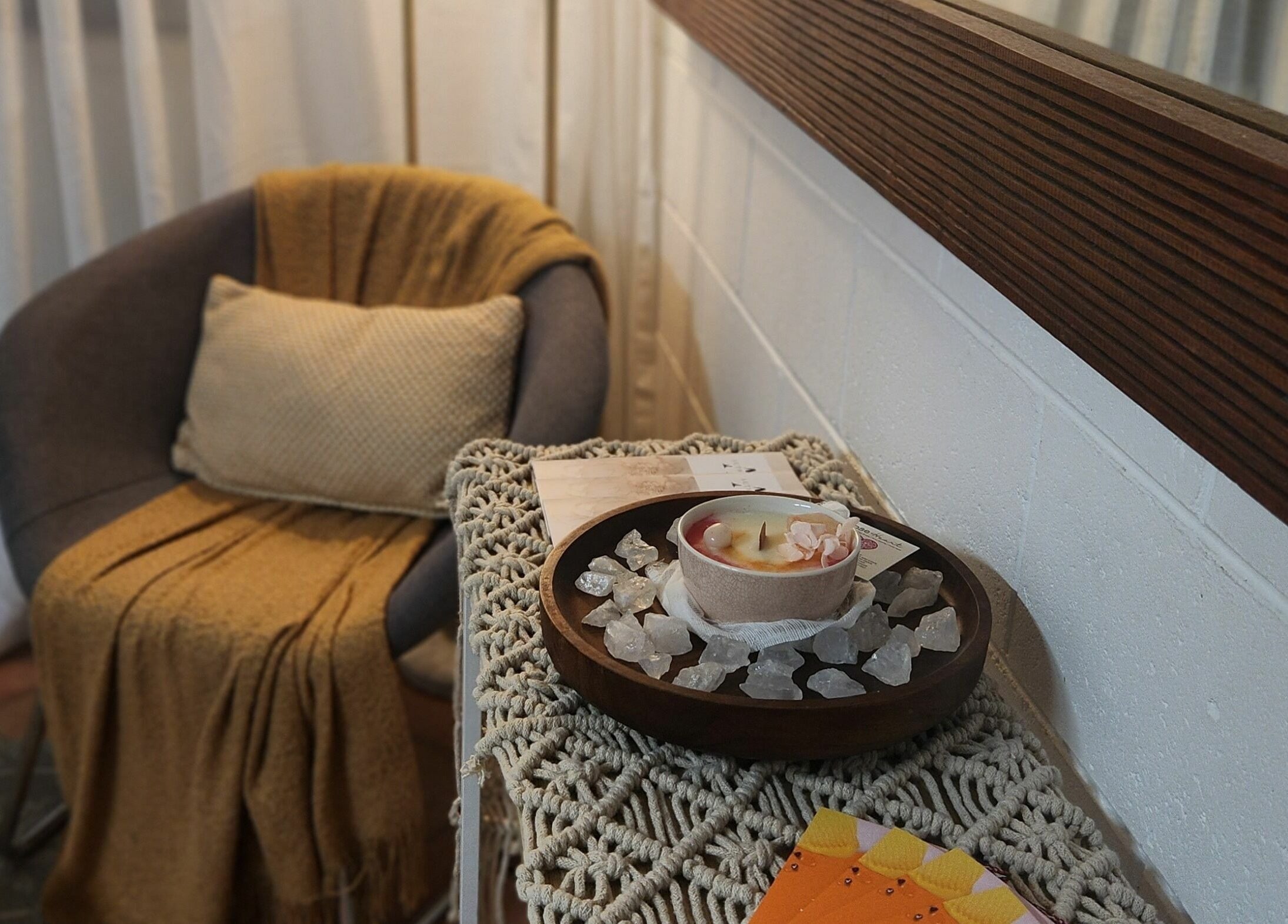 Cozy seating with candle and crystals at Authentic Zen Beauty, New Auckland, Queensland, AU.