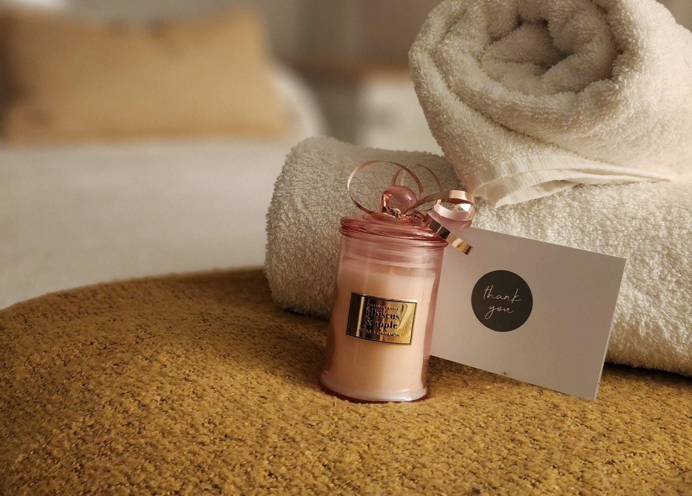 Luxurious towel and candle setting at Authentic Zen Beauty, New Auckland, Queensland, AU for ultimate relaxation.
