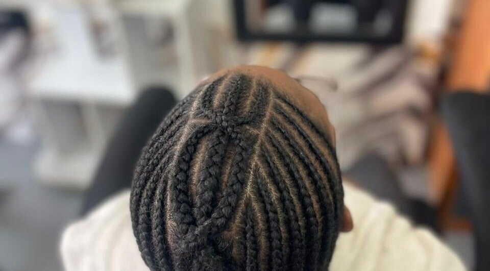 Intricate cornrows at Natural Hair KNHS, Pretoria, Gauteng, ZA, showcasing skilled styling.