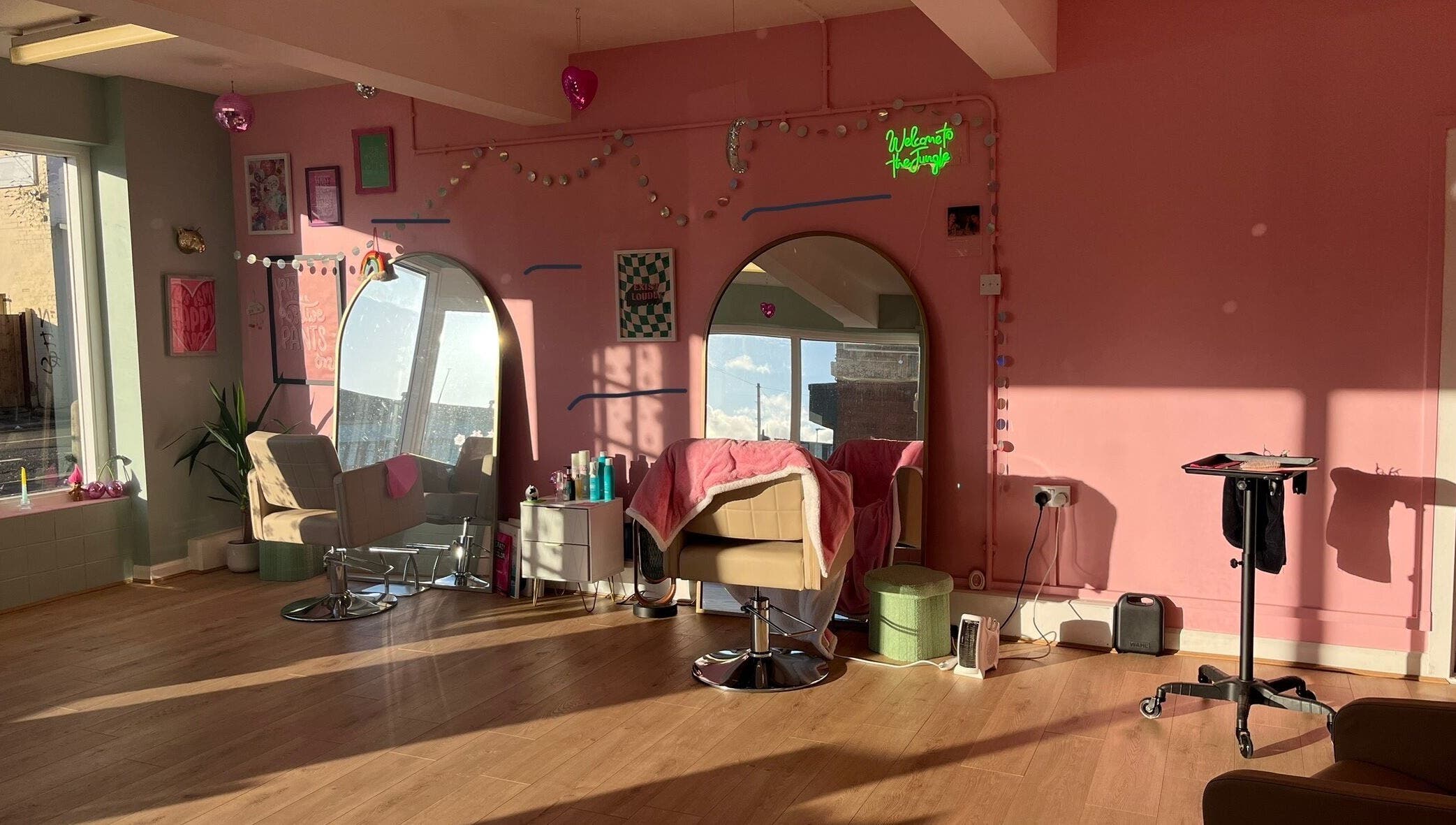 Bright and modern salon space at Empress Hair, Hull, England, GB with stylish decor and cozy styling chairs.