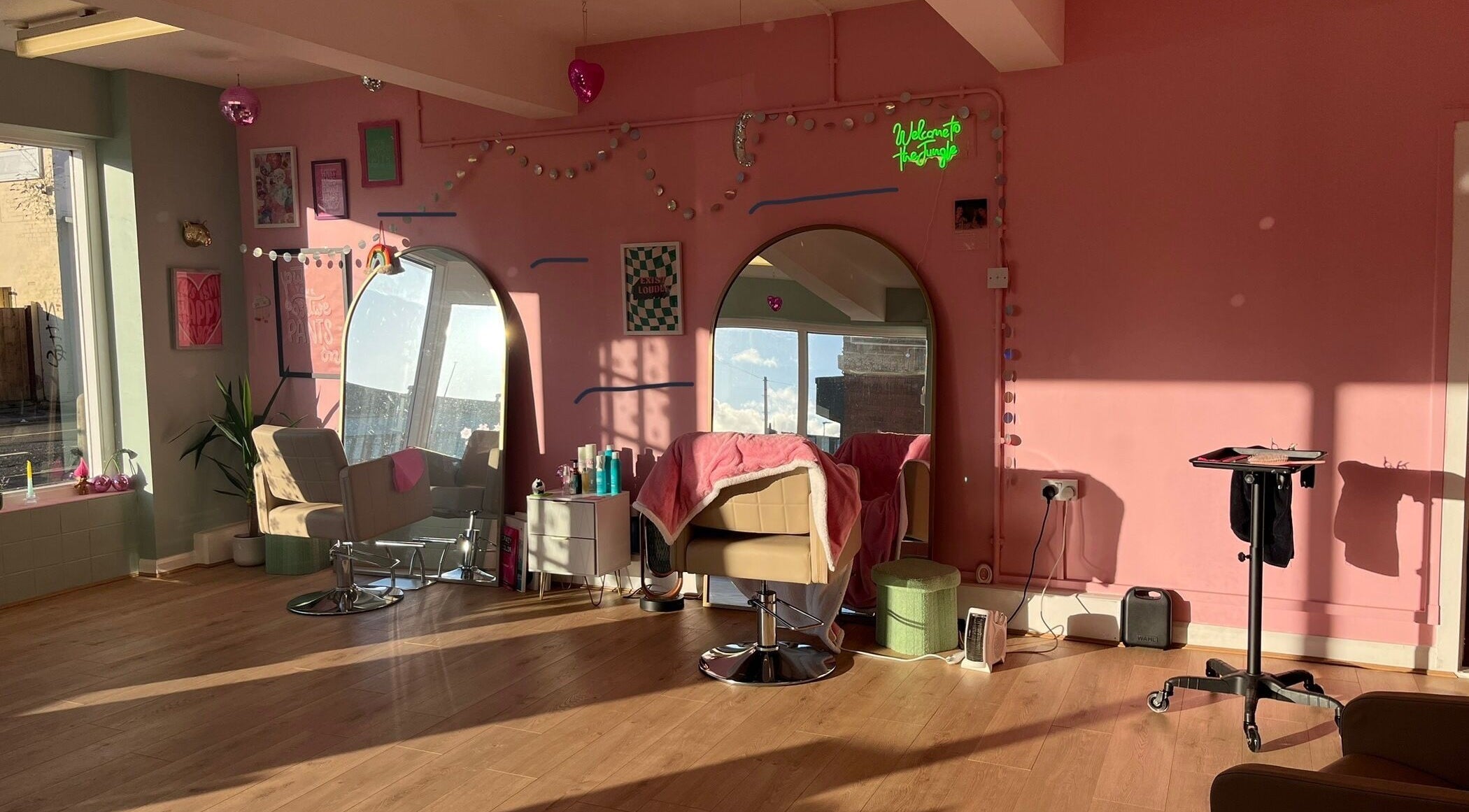 Bright and modern salon space at Empress Hair, Hull, England, GB with stylish decor and cozy styling chairs.