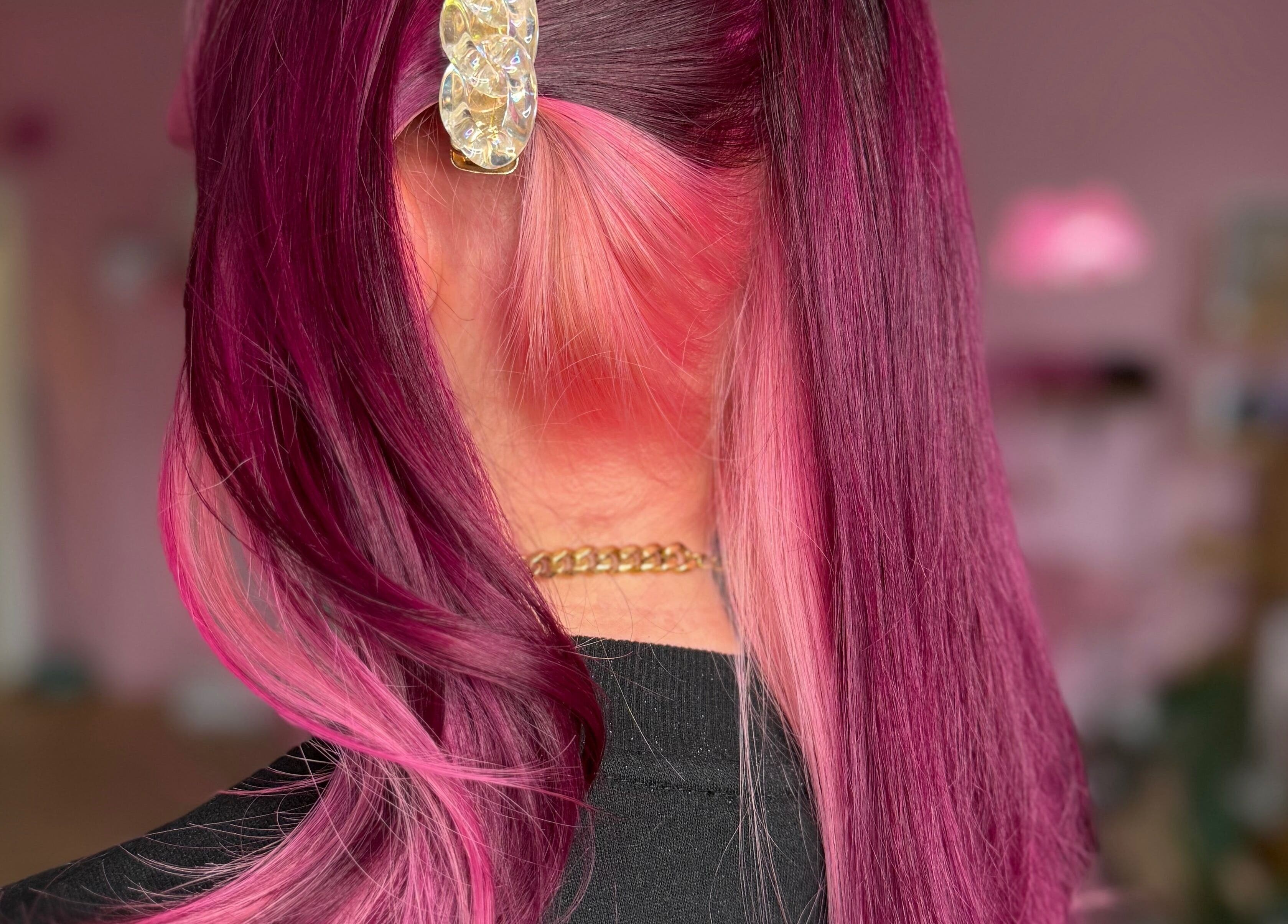 Vibrant pink hairstyle at Empress Hair, Hull, England, GB showcasing elegant styling with a decorative clip.