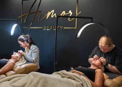 Technicians provide lash services at Armor Beauty, Knoxville, Tennessee, US in a modern, illuminated salon.