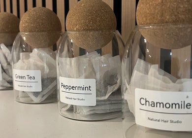 Assorted tea jars at Natural Hair Studio in Horsham, England, GB, featuring peppermint and chamomile.