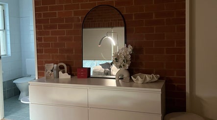 Elegant interior at Skiin Studio by Paige, Sydney, New South Wales, AU showcasing modern decor and mirror.