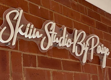 Elegant sign of Skiin Studio by Paige on brick wall in Sydney, New South Wales, AU.