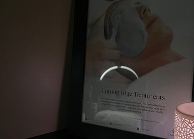 A framed spa treatment poster with soft lamp lighting at Skiin Studio by Paige in Sydney, New South Wales, AU.
