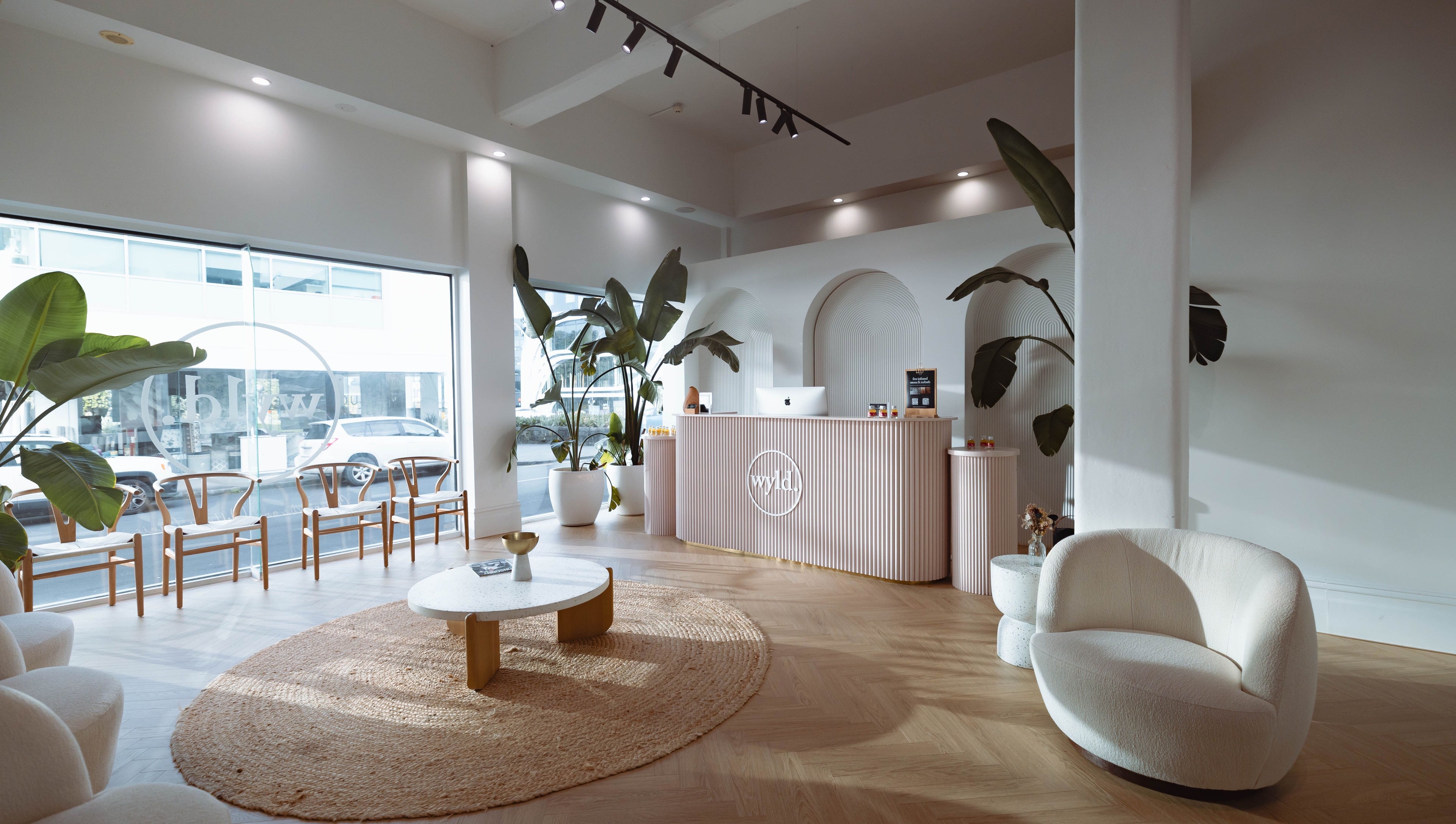 Sophisticated interior of WYLD Newmarket, Auckland, Auckland, NZ, featuring modern decor and lush plants.