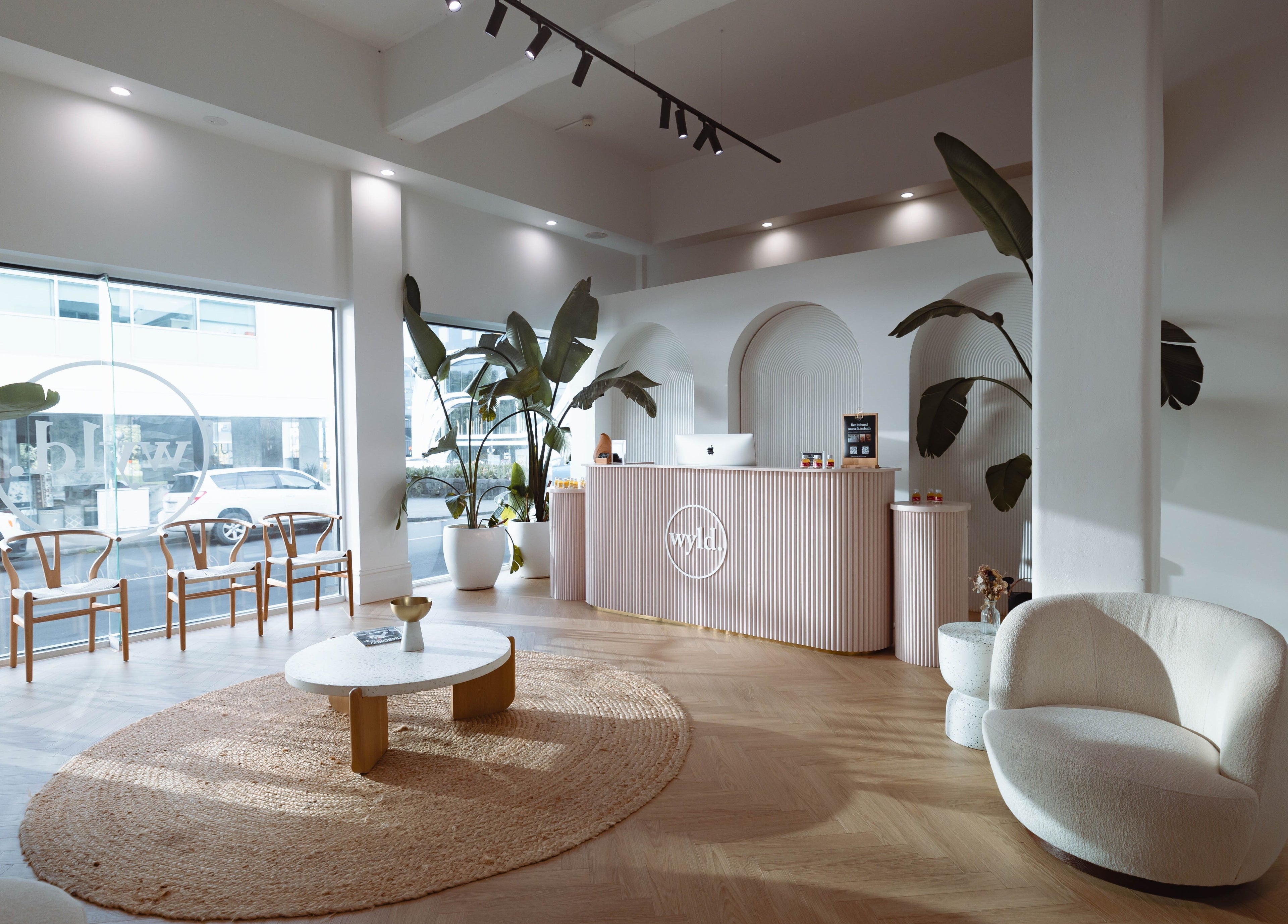 Sophisticated interior of WYLD Newmarket, Auckland, Auckland, NZ, featuring modern decor and lush plants.